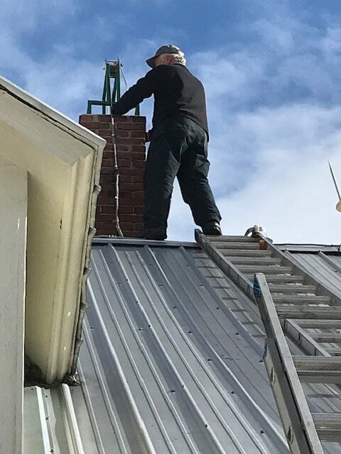 Cricket Chimney Service cleaning a Chimney